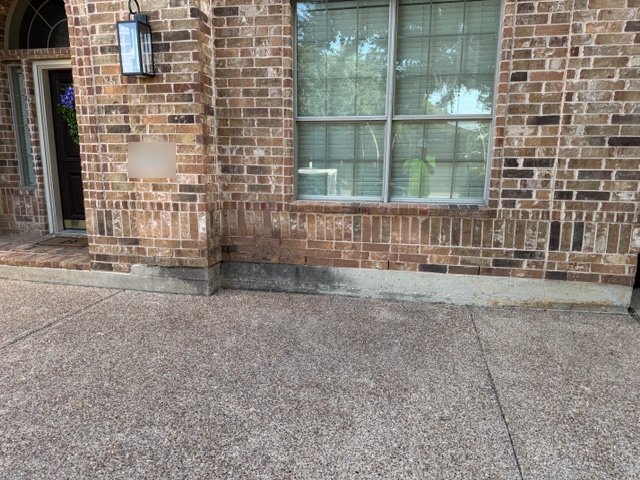 Brick entryway and concrete porch before softwashing
